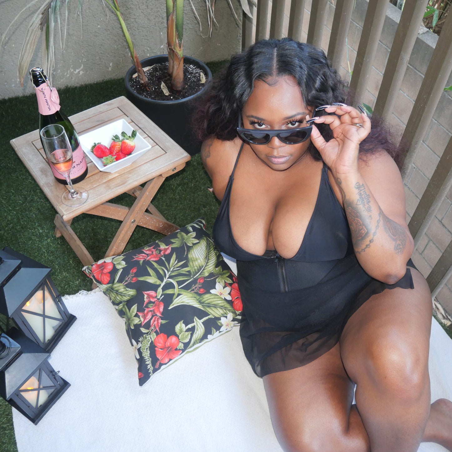 Black plus sized swimsuit with adjustable front zipper and attached mesh cover up