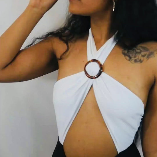 white and black bathing suit with adjustable brown ring for front cleavage. 