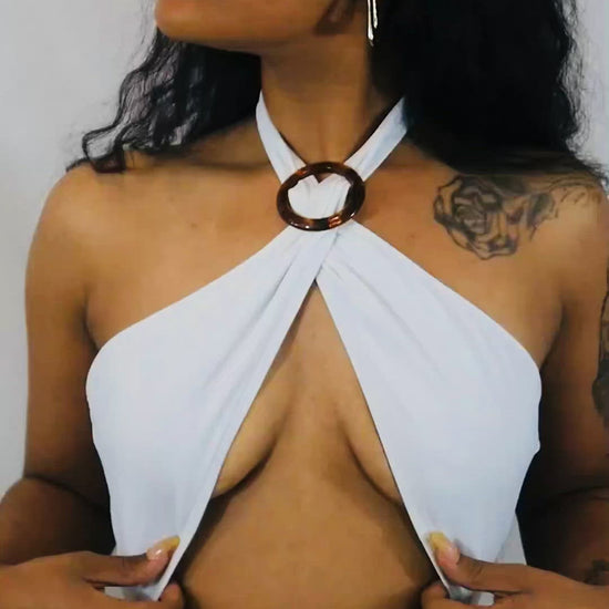 white and black bathing suit with adjustable brown ring for front cleavage.  